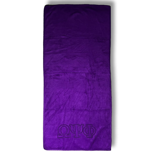 Purple towel with Omega Psi Phi logo on a white background