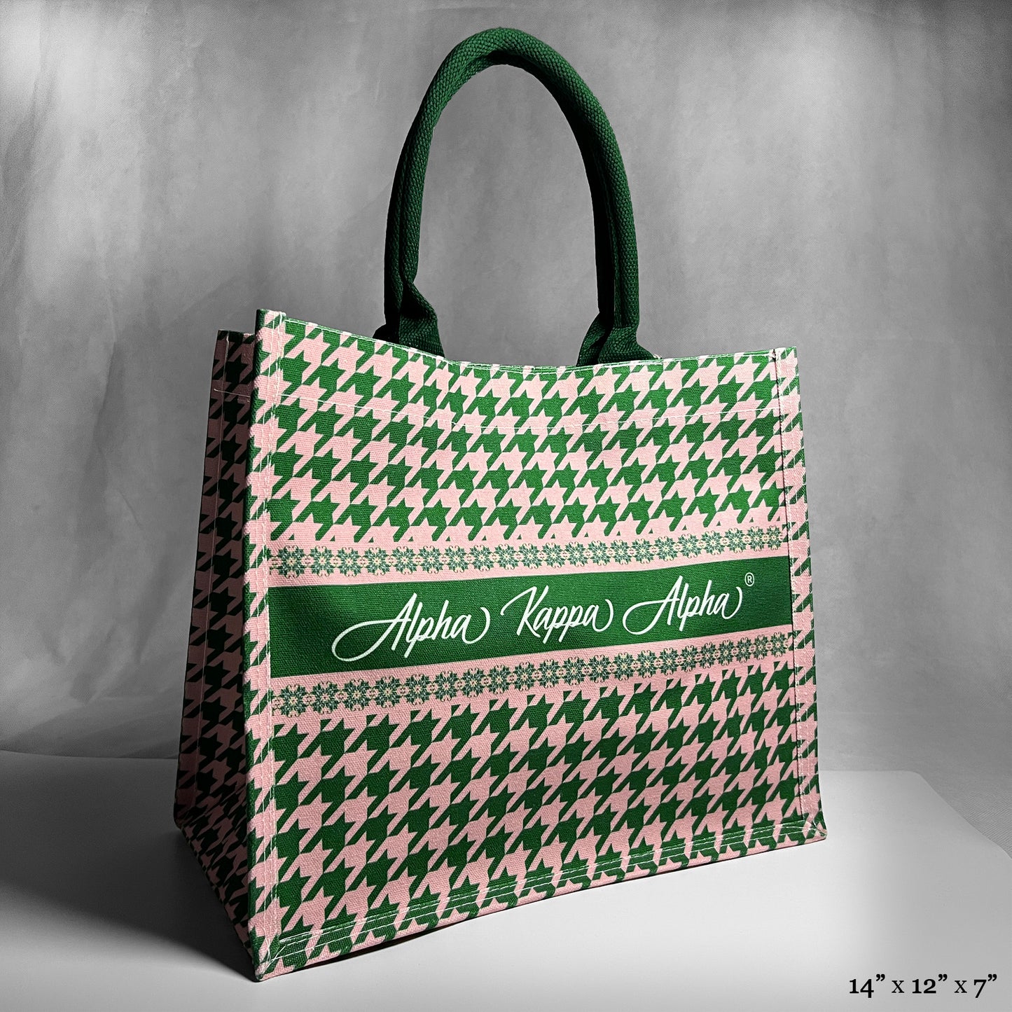 Tote bag with green and pink houndstooth pattern and 'Alpha Kappa Alpha' text in the center.