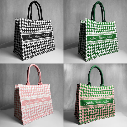 Four tote bags with houndstooth pattern and Alpha Kappa Alpha text.  Gray background