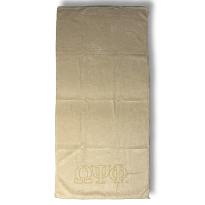 Old Gold towel with Omega Psi Phi logo on a white background
