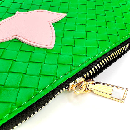 Green woven pouch with a pink ivy and gold zipper pull on a white background