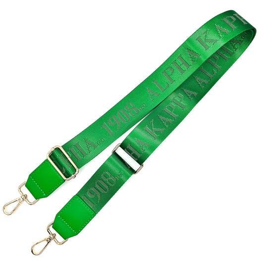 Green bag strap with debossed 'Alpha Kappa Alpha 1908' branding on a white background