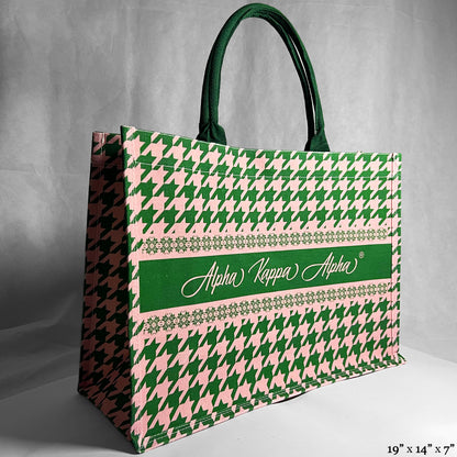 Tote bag with green and pink houndstooth pattern and Alpha Kappa Alpha text in the center.