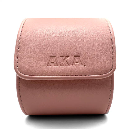 Pink leather case with 'A.K.A.' branding on a white background