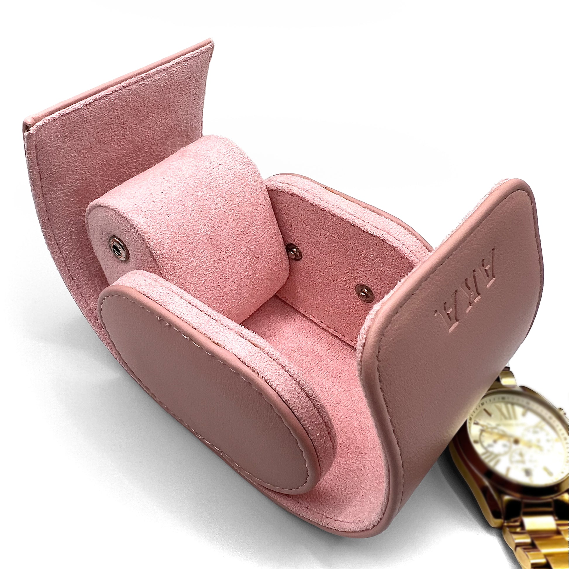 Pink jewelry box with a gold watch on a white background